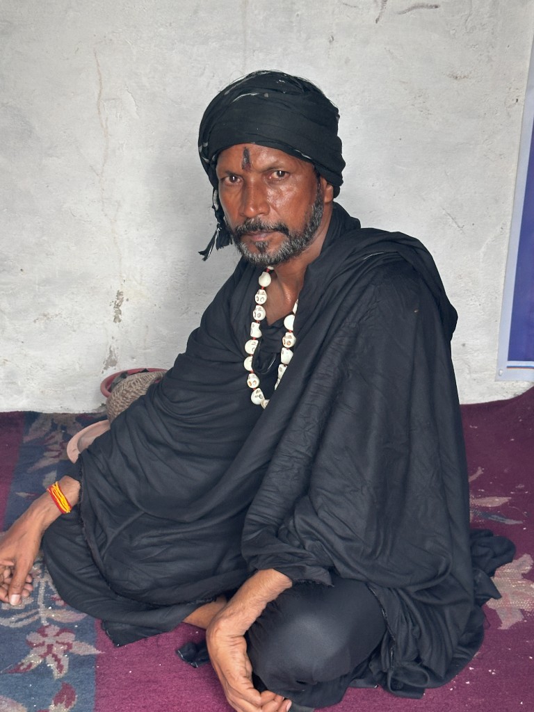 Mahakaalaghori Aghori guru in black attire with rudraksha mala — authentic Aghori tradition and sacred astrology power
